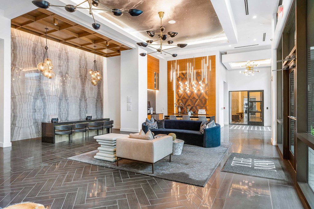 a lobby with couches and chairs and a chandelier