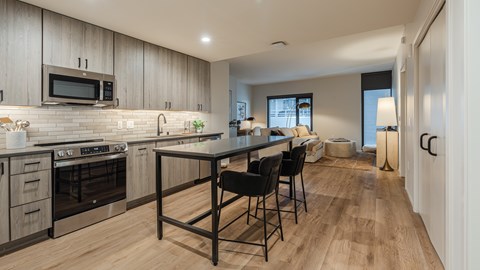A modern kitchen with a dining table and chairs.