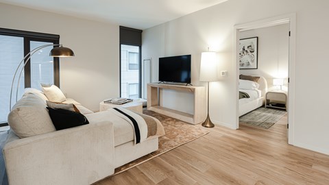 A living room with a white couch and a television.