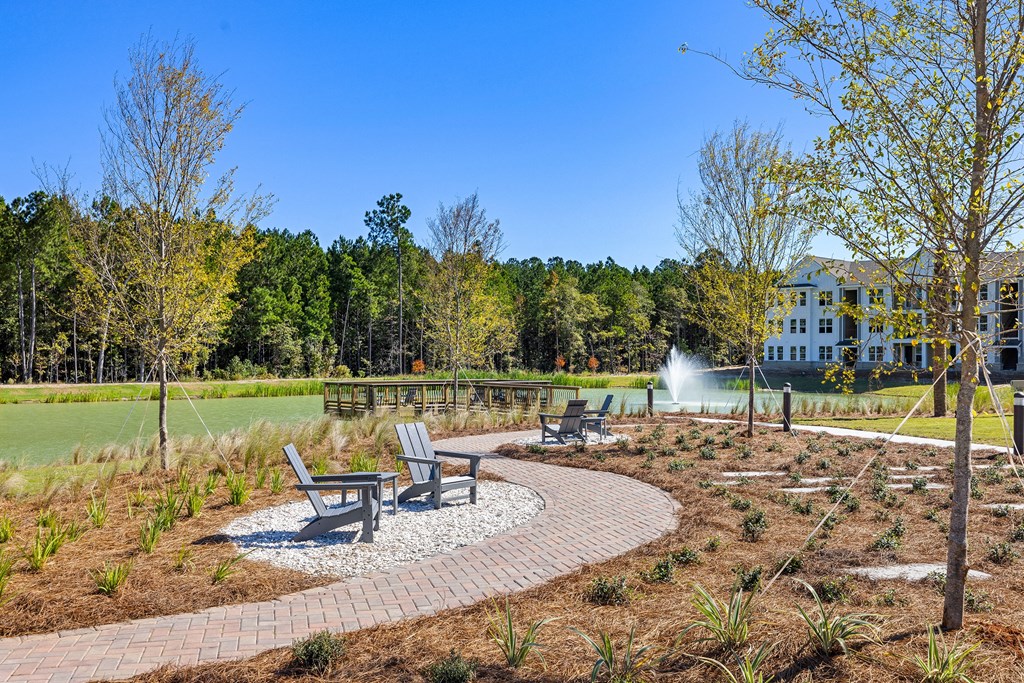 a park with benches and a pond with a community dock