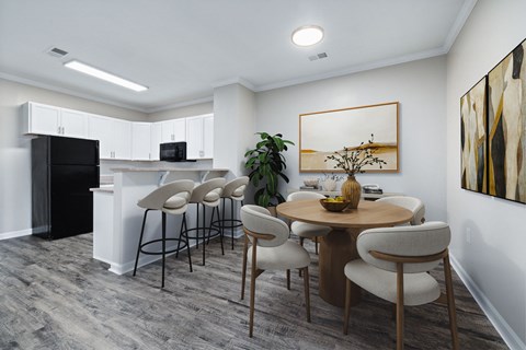 A modern kitchen with a dining table set for four.