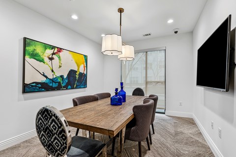A dining room with a wooden table and chairs.
