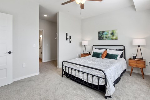 a bedroom with a bed and a ceiling fan