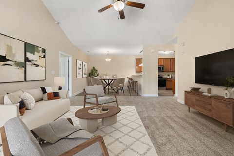A living room with a couch, chairs, and a coffee table.