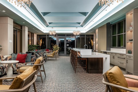 A well-lit dining area with a long table and chairs.