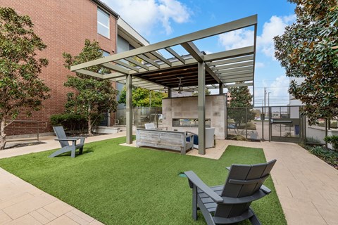 A patio with a table and chairs under a roof.