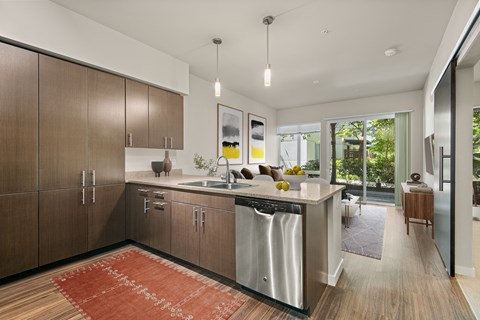 a modern kitchen with wooden cabinets and a large island with a sink