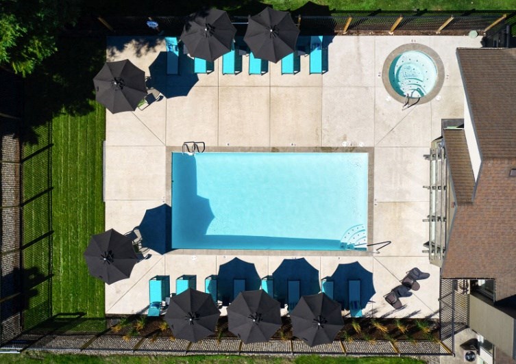 arial view of a pool with umbrellas and chairs