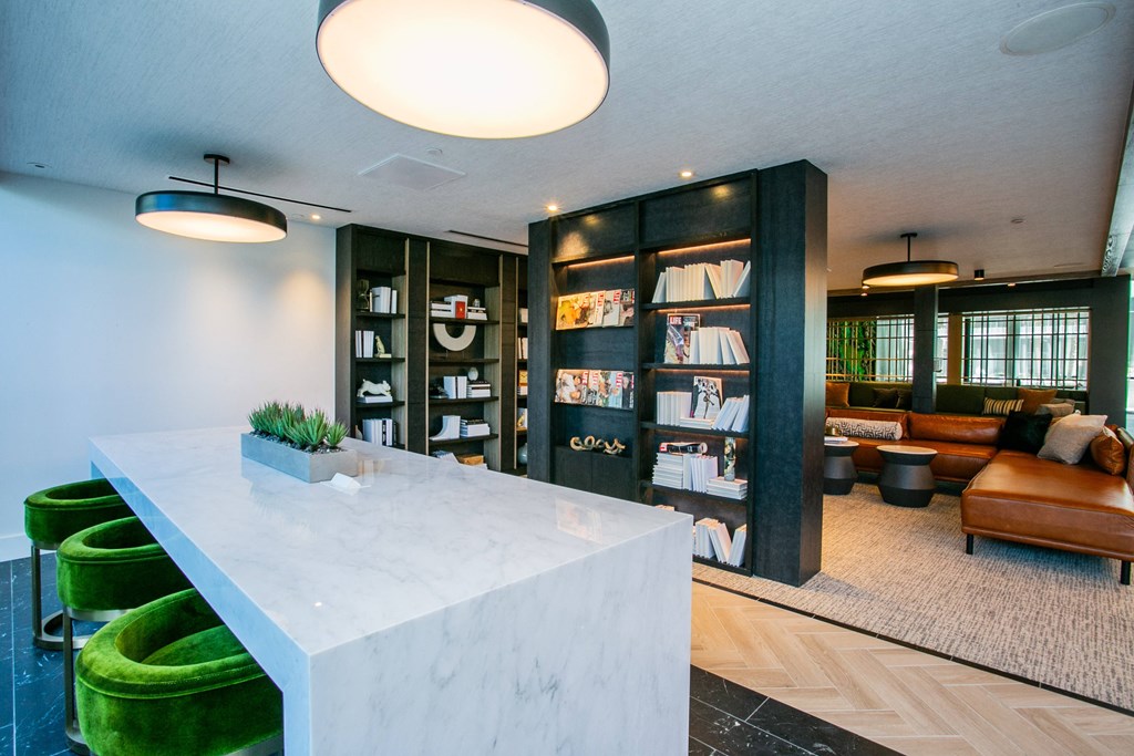 Lounge area filled with furniture and bookshelf  study area