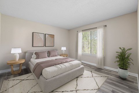 a bedroom with a bed and a large window