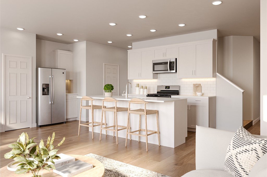 A modern kitchen with white cabinets and a central island.