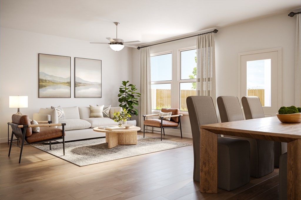 A modern living room with a white sofa, wooden coffee table, and a large window.