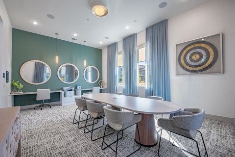 A conference room with a large table and chairs.