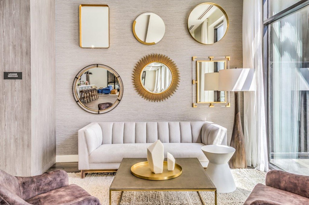 resident lounge seating area with a white couch and mirrors on the wall