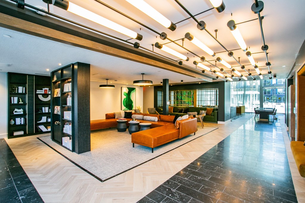 Lounge area with couch and chairs, bookshelf study area.