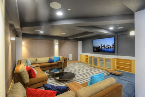 A modern living room with a large couch and a television.
