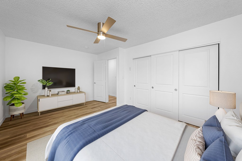 A bedroom with a large bed and a television.