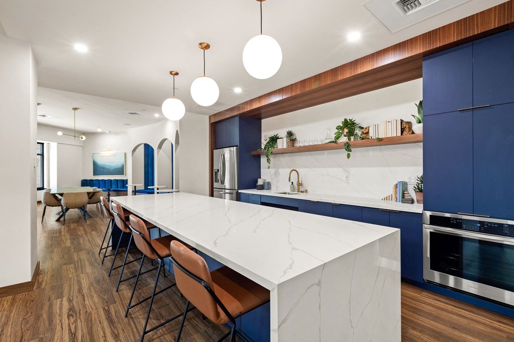 a large kitchen with blue cabinets and a white counter top