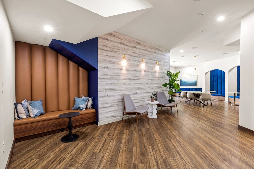 a living room with wooden floors and a blue accent wall