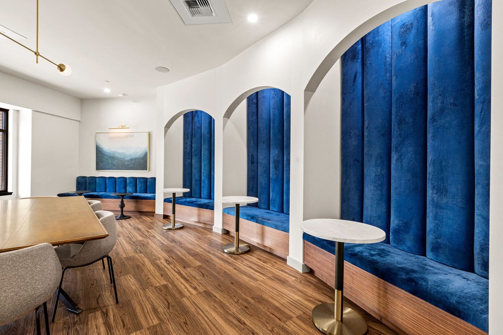 a dining room with blue booths and tables