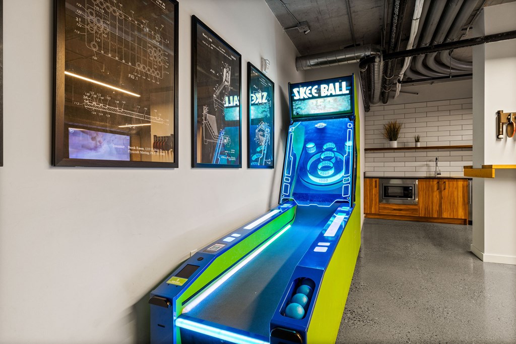 A Skee Ball arcade game is in the middle of a room.