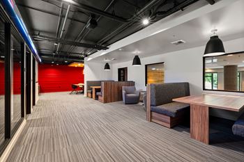 A modern office space with wooden floors and furniture.