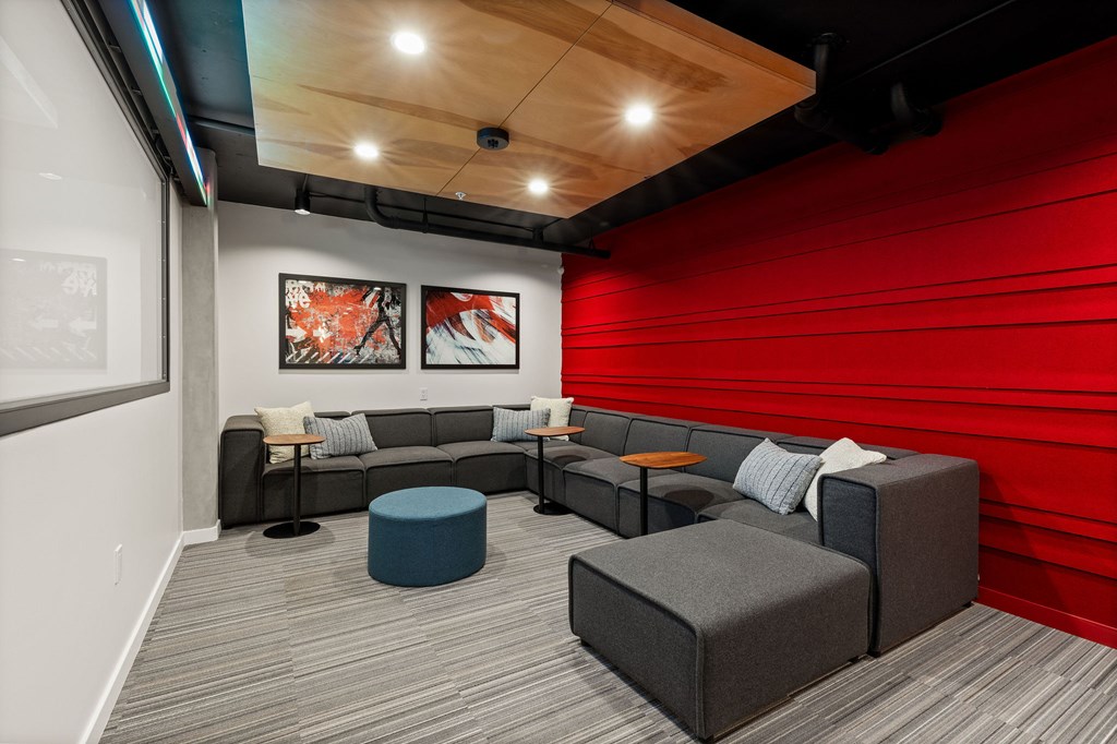 A modern lounge area with grey and blue seating.