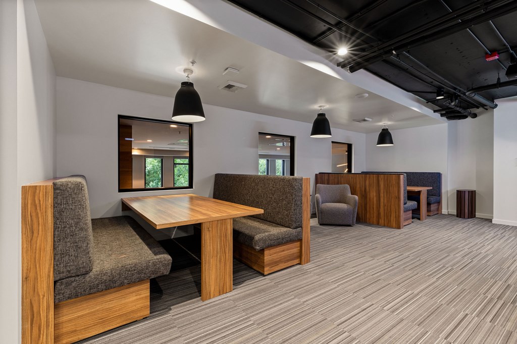A conference room with a long table and chairs.