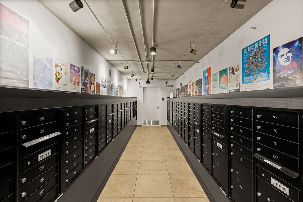 A long hallway with black drawers on both sides and posters on the wall.
