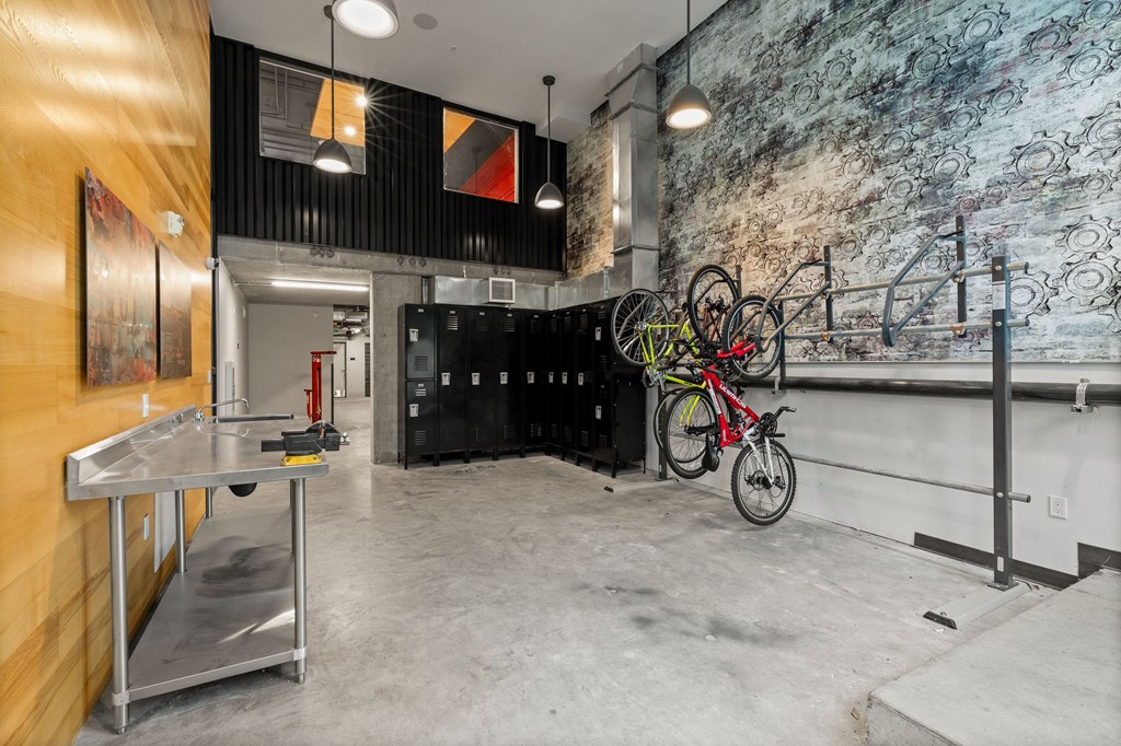 A room with a bicycle hanging on the wall.