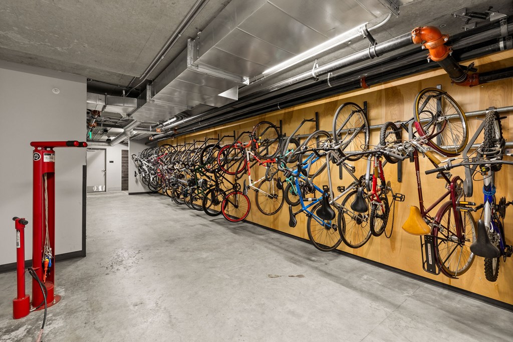 A bike rack with many bikes hanging on it.