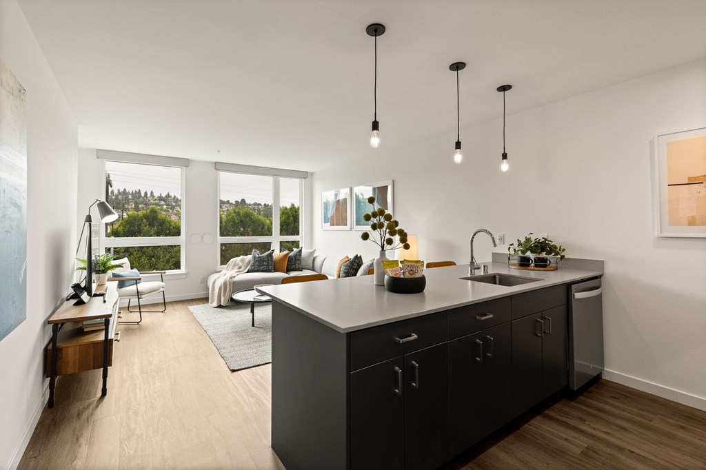 A modern kitchen with a large island and a view of the outdoors.