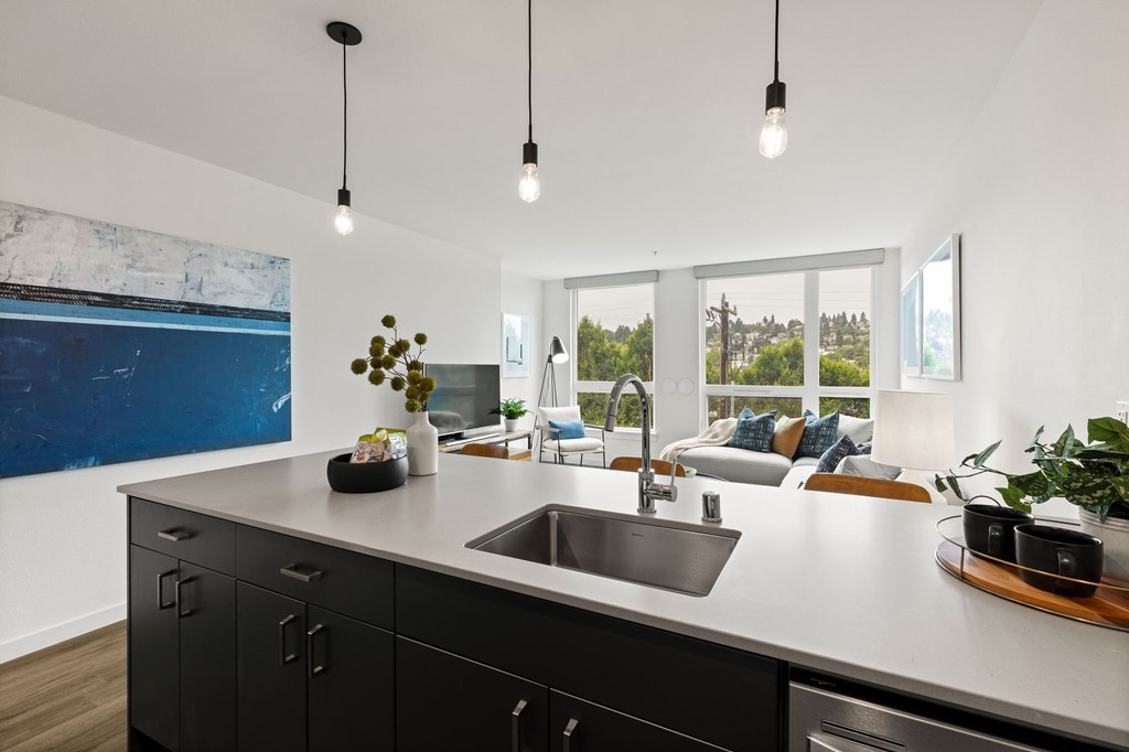A modern kitchen with a large island and a view of the outdoors.