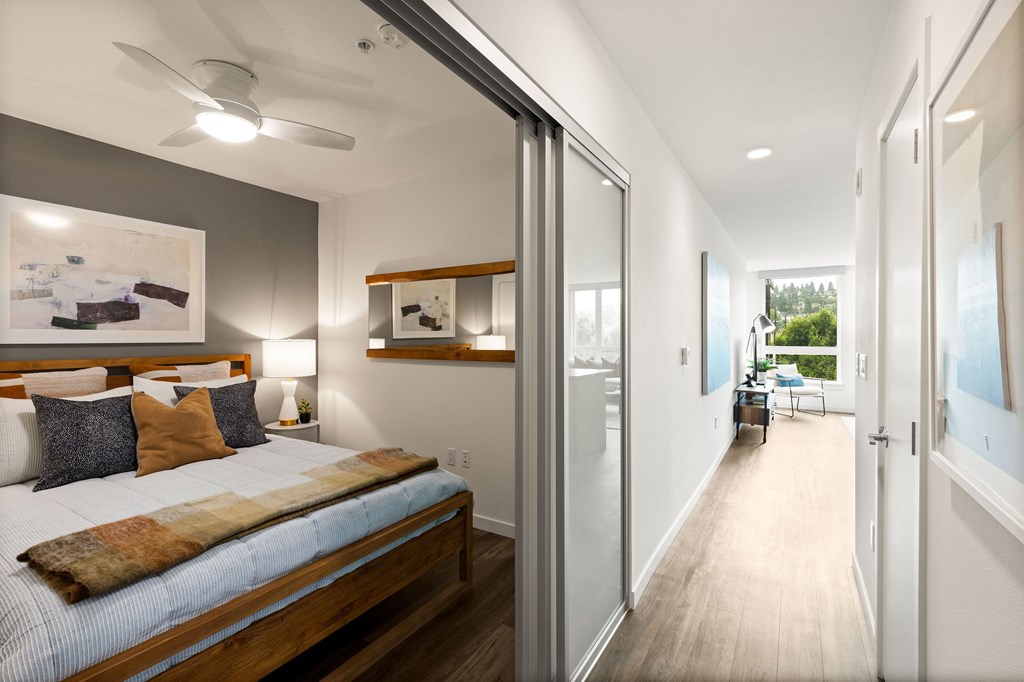 A bedroom with a bed and a painting on the wall.