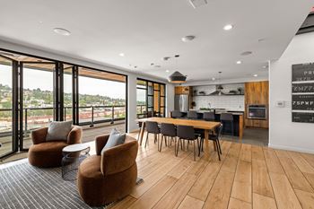 A modern living room with a dining table and chairs.