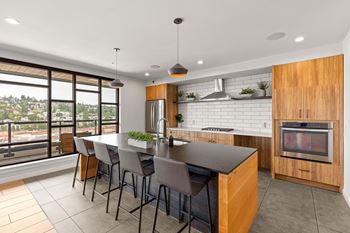 A modern kitchen with a large island and a view of the city.