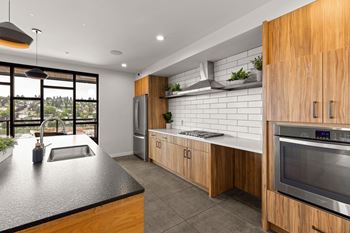 A modern kitchen with wooden cabinets and stainless steel appliances.