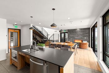 A modern kitchen with a wooden island and stainless steel appliances.