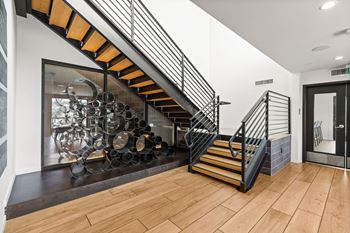A staircase with a black metal railing and wooden steps.