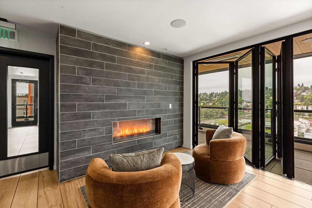 A modern living room with a fireplace and a view of the outdoors.
