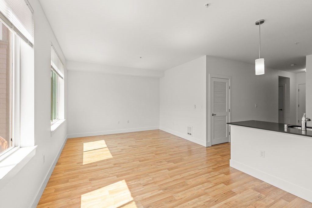 A room with wooden floors and white walls.