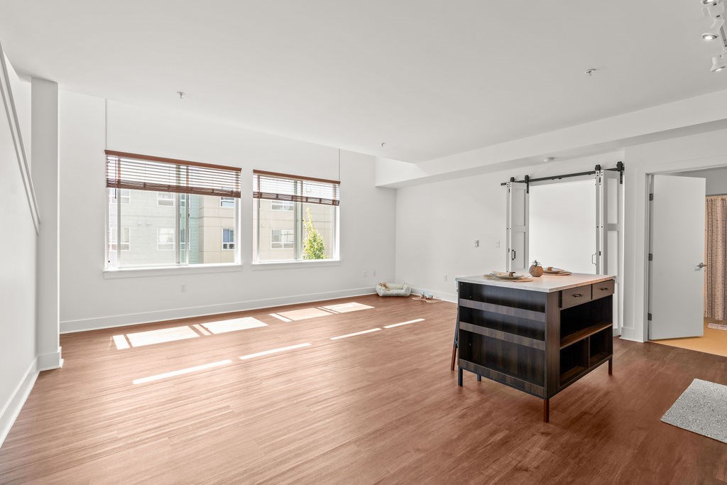 A room with a wooden floor and a desk with a chair.