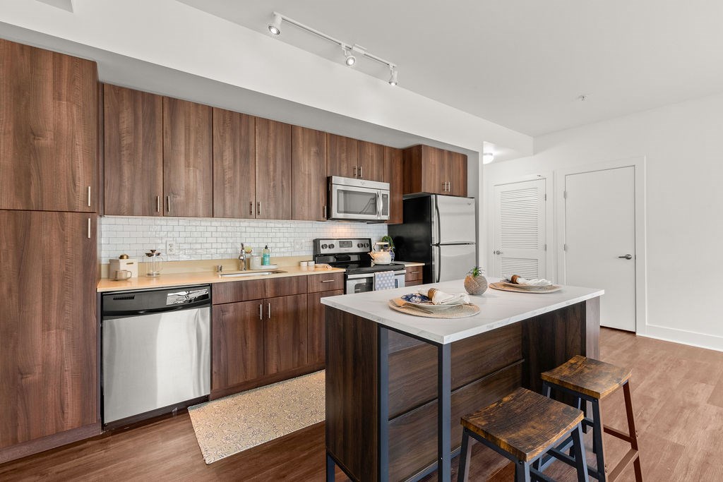A kitchen with wooden cabinets and a white countertop.