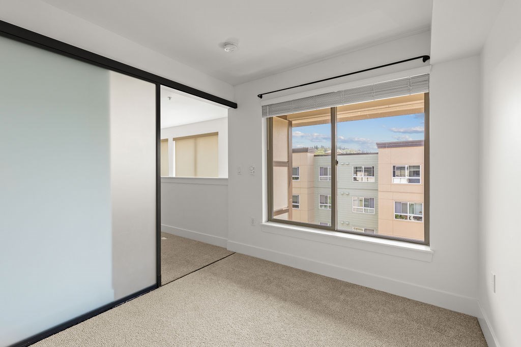 A room with a large window and a sliding door.