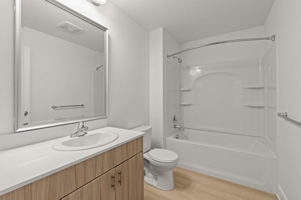 A white bathroom with a sink, toilet, and bathtub.