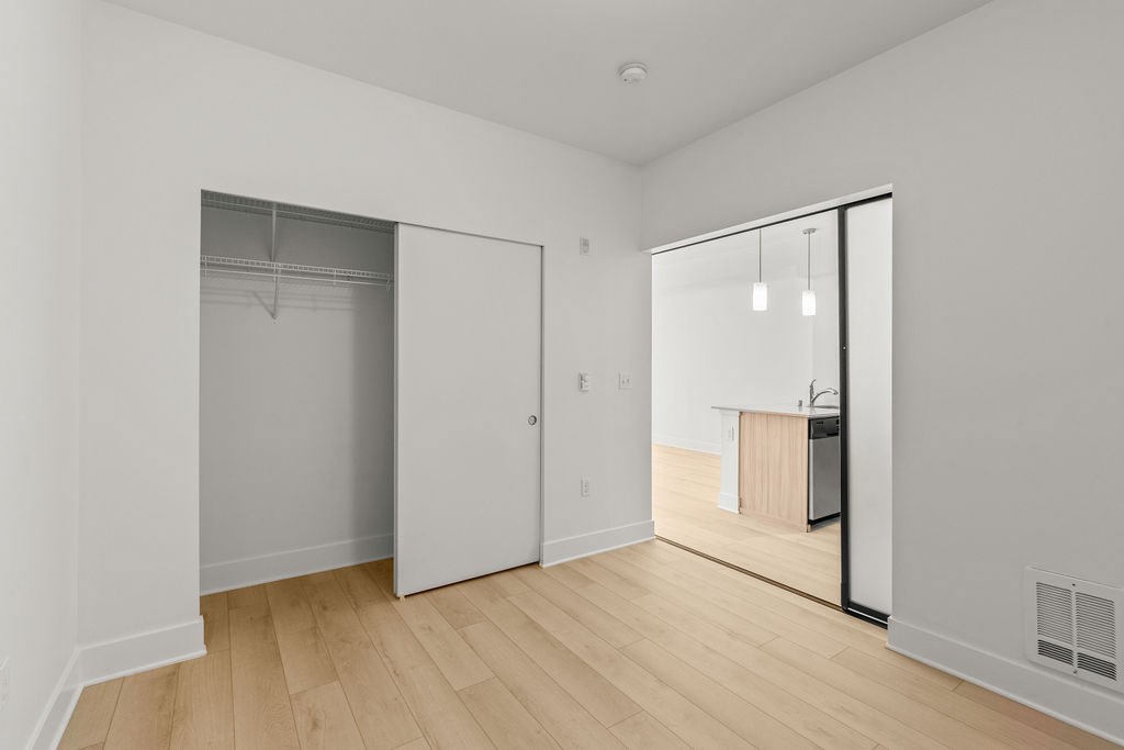 A room with a white door and a white wall.