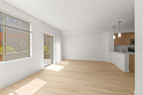 Open living space with modern kitchen and balcony access at Six Oaks Apartments, Washington