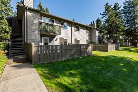 A building with a green lawn in front.