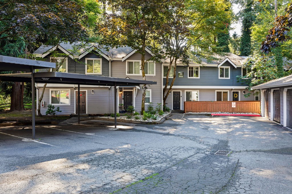 A row of houses with a driveway in front.