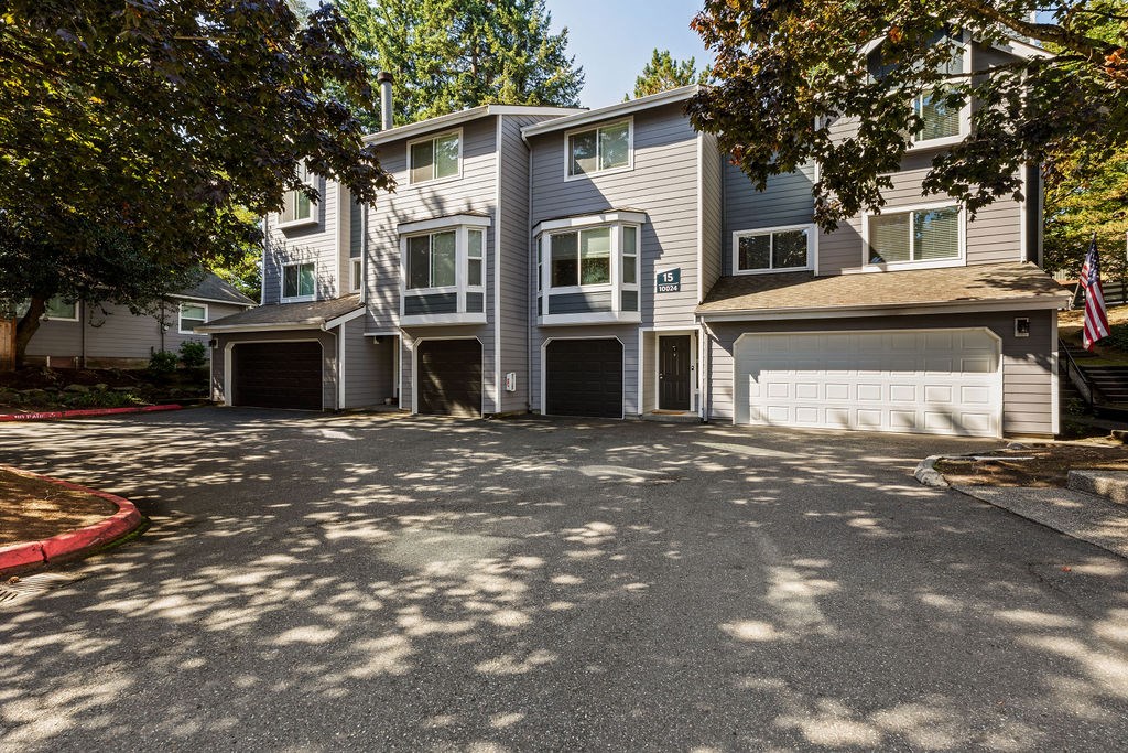 A large grey building with a red curb in front.